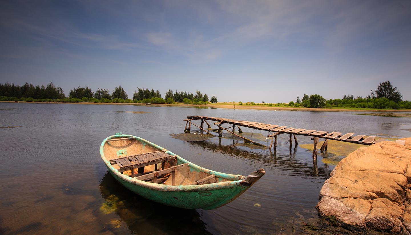 Guinea - Small pier with boat in a pond, Guinea